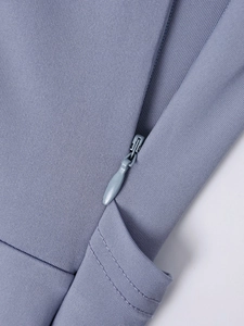 Detail of invisible zipper closure on light purple ruched dress with premium knit fabric