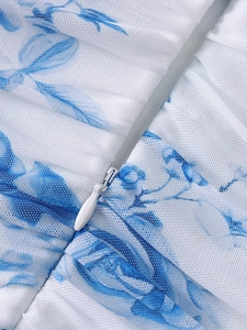 Detail of floral mesh dress featuring a hidden zipper and delicate blue flower patterns
