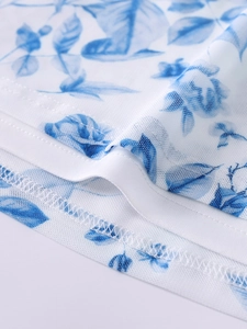 Detail view of floral print mesh fabric with high-quality double-needle stitching and finish