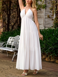 Detail of white deep V-neck halter maxi dress with ruffled tiers and high waist design