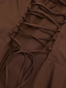 Detailed view of the dark brown criss-cross lace-up design on the back of a long dress