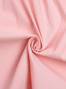 Close-up of soft pink chiffon fabric with subtle vertical texture and light layering