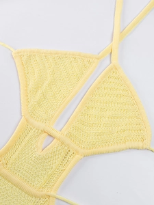 Detailed knit texture of light yellow halter crochet dress with triangle cup cutouts