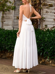Elegant white backless maxi dress with halter neck and bow tie detail for vacation