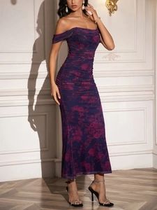Detail of off-shoulder mesh evening dress with red rose print and gathered fishtail design