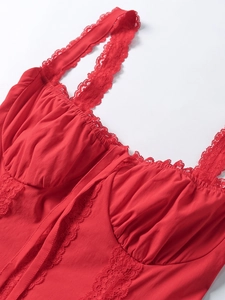 Detail of red bustier top with eyelash lace trim and square neckline stitching