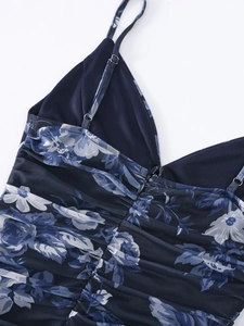 Detail of blue floral mesh dress showing thin straps, hidden zipper and ruched texture