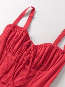 Close-up of red bodycon dress with corset-style fishbone seams and drawstring bust