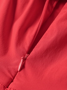 Detailed macro view of high-quality invisible zipper on a red A-line party dress