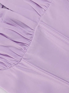 Detailed close-up of lavender pleated fabric with precision stitching on a bodycon dress