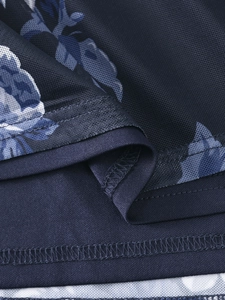 Macro detail of blue floral mesh fabric with high-quality overlock stitching on the hem