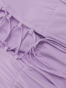 Detail of lavender dress with corset-style lace-up ties and pleated woven fabric texture
