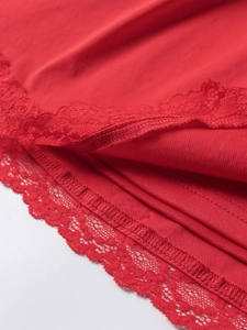 Detail view showing delicate red lace hem and fine fabric texture of the A-line dress