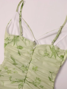 Detail of ruched mesh dress with green leaf print, spaghetti straps and invisible zipper