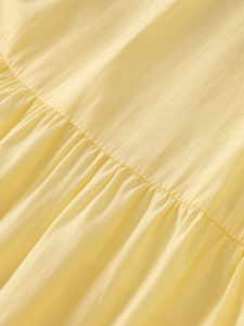 Detail of light yellow four-way stretch fabric with elegant ruffling and fine texture