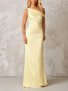 Detailed close-up of pale yellow satin one-shoulder evening gown with elegant draping