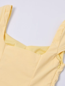 Detail of square neckline and invisible zipper on light yellow minimalist A-line dress