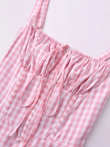 Detail of pink gingham corset bodice with thin straps and lace-up front drawstring