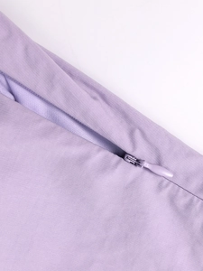 Detail view of the seamless invisible zipper on lavender purple A-line dress fabric
