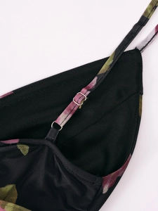 Detail of adjustable shoulder strap on floral mesh dress with silver metal hardware