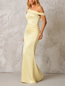 Detailed view of the elegant ruched pleats on this yellow satin one-shoulder dress