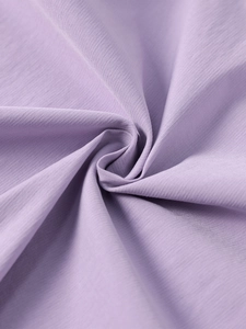 Close-up of lilac fishbone dress fabric with soft vertical texture and elegant draping