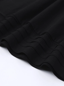 Detailed macro view of the black dress hemline with professional triple-stitched decorative seams