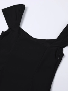 Detail of the invisible side zipper and wide shoulder straps on this black square neck dress