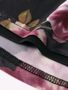 Close-up of printed mesh fabric showing intricate pink floral patterns and stitching