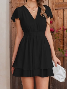 Detail of elegant black V-neck chiffon dress with elastic waist and ruffled hemline