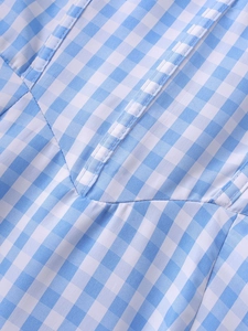 Detail shot of the light blue gingham fabric showing high-quality stitching and texture