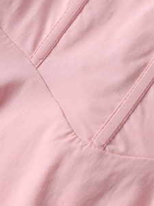 Macro shot of pink fishbone dress fabric showing detailed texture and structural stitching