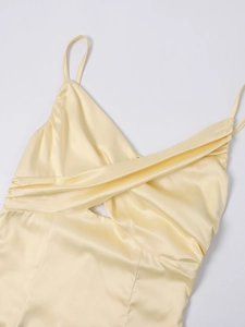 Detailed close-up of pale yellow satin dress featuring a twist front and cut-out design