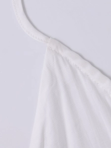 Close-up of V-neck stitching and thin straps on a white four-way stretch maxi dress