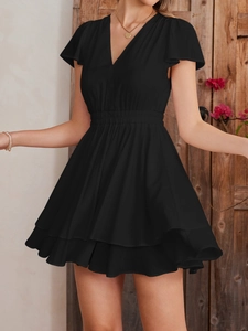 Detail of elegant black V-neck mini dress with ruffled sleeves and elastic high waist