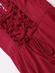 Detail of red floral dress with front lace-up corset ties and fine stitching finish