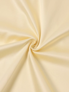 Detailed view of the smooth beige satin fabric showing its glossy texture and drape