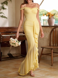 Detail of yellow off-shoulder dress with layered ruffles and elegant ruching texture
