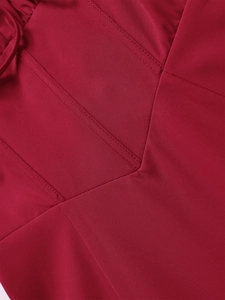 Detailed close-up of dark red woven fabric featuring precise decorative topstitching