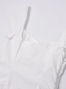 Detail of square neckline with wide quilted straps and side invisible zipper on white dress