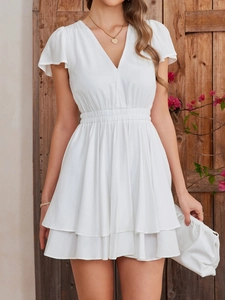 Detail of elegant white V-neck dress with ruffled sleeves and high waist pleated design