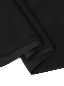 Close-up of black four-way stretch fabric showing double-needle stitching and texture
