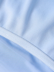 Macro detail of breathable light blue mesh fabric with reinforced stitching and fine texture