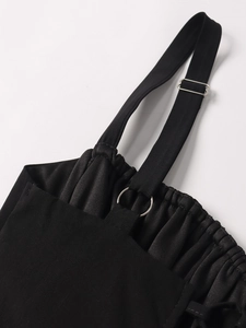 Detail of black corset dress with vertical texture and adjustable silver metal buckles