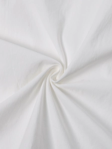Detailed macro shot of premium white cotton fabric with fine vertical texture for soft dresses