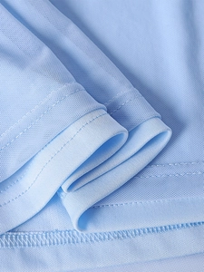 Close-up of light blue mesh fabric showing breathable texture and neat stitching details
