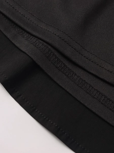Close-up of black dress hem showing professional double-needle stitching and fabric texture