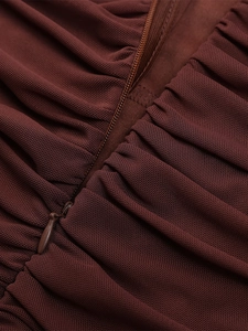 Detail of invisible zipper and pleated mesh fabric on a sexy backless bodycon dress