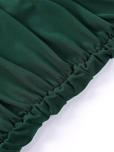 Detailed macro view of dark green ruched mesh fabric with fine grid texture and elastic seams