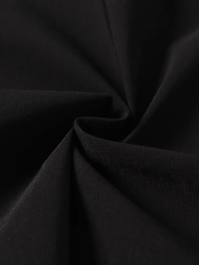 Close-up of premium black woven fabric with subtle texture and elegant spiral folding